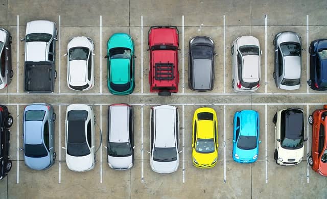Aerial view of amulti coloured cars parked in bays